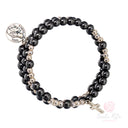 Bracciale a spirale in ematite con perle e medaglia di Santa Rita