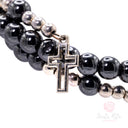 Bracciale a spirale in ematite con perle e medaglia di Santa Rita