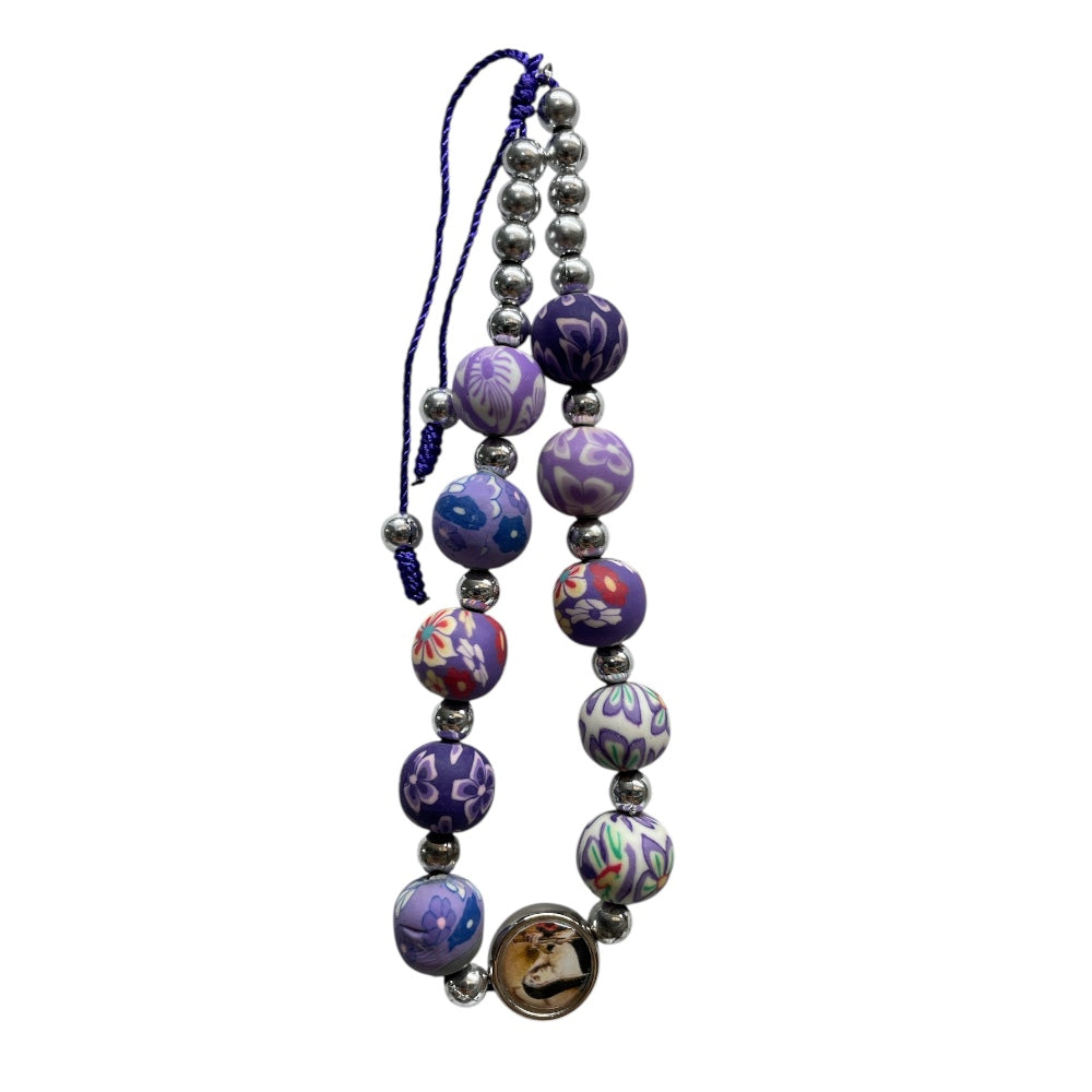 Bracciale in corda con grani viola e immagine Santa Rita